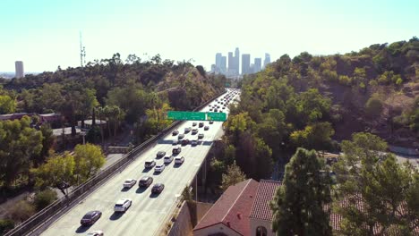 Aerial-Freeway-Cars-Travel-Along-The-110-Freeway-In-Los-Angeles-Through-Tunnels-And-Towards-Downtown-Skyline-2