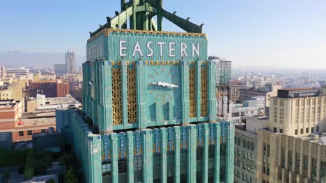 Aerial-Of-The-Historic-Eastern-Building-In-Downtown-Los-Angeles-With-Clock-And-Downtown-City-Skyline-Behind-3