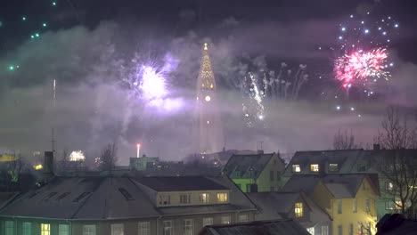 Fireworks-go-off-on-New-Year's-Eve-in-Reykjavik-Iceland-with-the-Hallgrimskirkja-church-in-sight-2