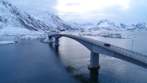 A-Van-Drives-Across-A-Bridge-On-The-Wintry-Lofoten-Islands-Norway-1