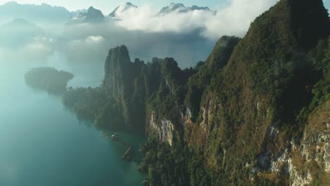 An-Aerial-View-Shows-Green-Mountains-And-Harbor-Lodgings-Among-The-Clouds-At-Khao-Sok-National-Park-In-Surat-Thani-Thailand