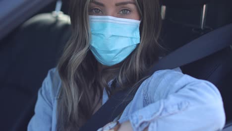 A-cleared-woman-with-mask-shows-ID-at-a-drive-through-test-clinic-during-the-Covid19-coronavirus-pandemic-epidemic