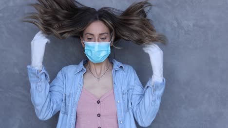 A-cleared-female-nurse-or-woman-with-mask-puts-on-a-mask-during-the-Covid19-coronavirus-pandemic-epidemic