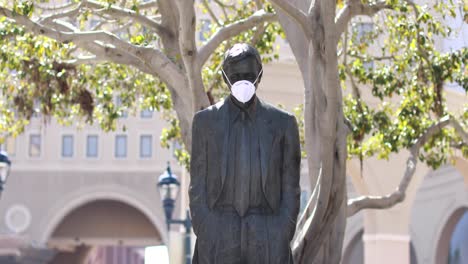 A-statue-in-a-park-wears-a-Covid19-mask-during-the-Covid19-coronavirus-pandemic-epidemic