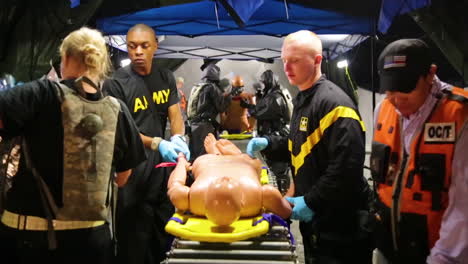 As-Part-Of-A-Us-Armed-Forces-Training-Exercise-Soldiers-Wrap-Foil-Around-A-Mannequin-Standing-In-As-A-Radiological-Attack-Victim