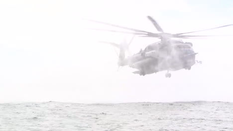 Us-Navy-Sailors-Fly-A-Helicopter-As-Part-Of-Helocast-Training