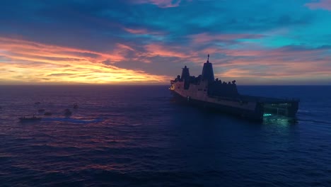 Aerial-Drone-Footage-Of-A-Large-Military-Boat-With-Its-Hatch-Open-To-Receive-A-Test-Re-Entry-Spacecraft-Sunset-2019