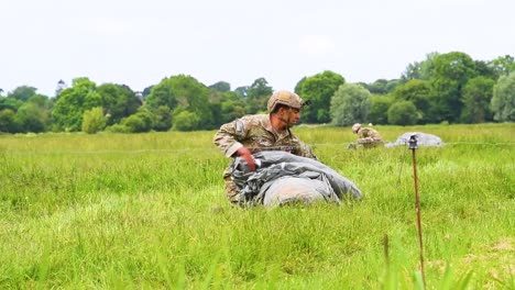 A-Landed-Paratrooper-Collects-His-Parachute-After-Landing-In-A-Field-Near-Saintemereeglise-France-For-the-75th-Commemoration-Of-Dday-June-9th-2019
