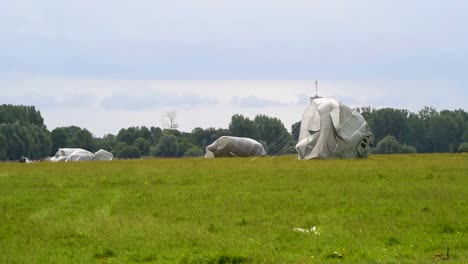 Paratroopers-Land-And-Remove-their-Parachutes-In-A-Field-Near-Saintemereeglise-France-For-the-75th-Commemoration-Of-Dday-June-9th-2019