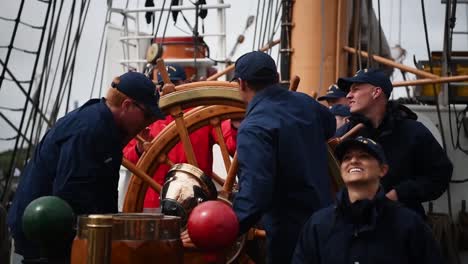 Members-Of-the-Us-Coast-Guard-Spin-the-Steering-Wheel-Of-the-Uscgc-Eagle-(Wix327)-While-Taking-Part-In-the-Tall-Ships-Festival