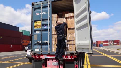 Customs-And-Border-Patrol-Officers-At-the-Port-Of-New-York/Newark-Inspect-A-Shipment-Of-Boxes-From-China