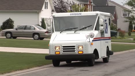 Us-Postal-Vehicles-Deliver-Mail-In-Suburban-Neighborhoods