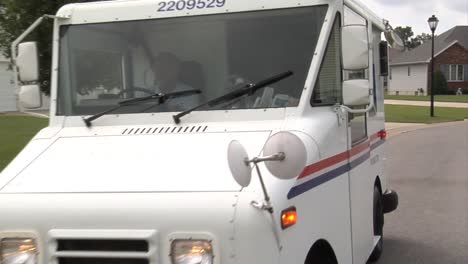 Us-Postal-Vehicles-Deliver-Mail-In-Suburban-Neighborhoods-4