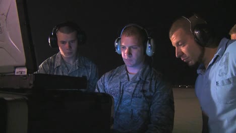 Air-Force-Personnel-Prepare-To-Fly-A-Unmanned-Drone-Surveillance-Aircraft-From-A-Computer-Workstation-On-The-Tarmac