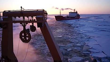 A-Coast-Guard-Icebreaker-Ship-Cuts-A-Path-Through-Arctic-Ice-For-A-Cargo-Vessel