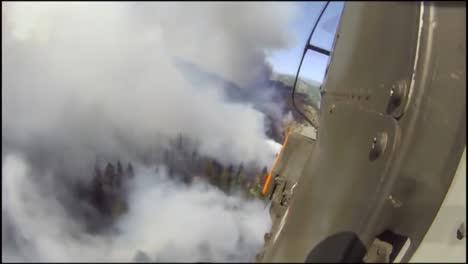 Pov-Shot-Of-A-Helicopter-Makes-Water-Drops-On-A-Forest-Fire