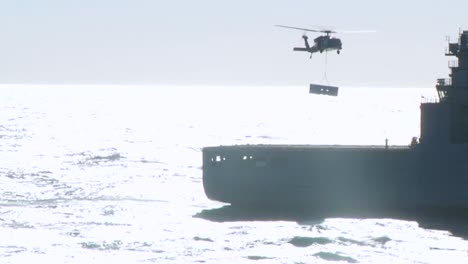 A-Navy-Helicopter-Lands-On-The-Deck-Of-A-Military-Ship-And-Drops-A-Container