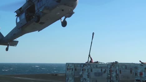 A-Navy-Helicopter-Lifts-Items-Off-The-Deck-Of-An-Aircraft-Carrier-During-A-Operation-5