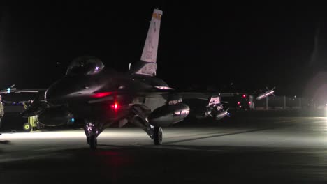 A-F16-Fighter-Jet-Taxis-On-A-Runway-At-Night-1