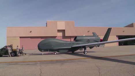 A-Rq4-Surveillance-Drone-Is-Rolled-Out-Onto-A-Runway-By-Military-Personnel