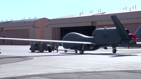 An-Rq4-Surveillance-Drone-Is-Towed-Pas-A-Hangar-For-Maintenance
