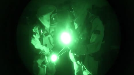 Night-Vision-Of-Men-In-Biohazard-Suits-Entering-An-Industrial-Area-And-Searching-For-Chemical-Leaks