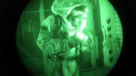 Night-Vision-Of-Men-In-Biohazard-Suits-Entering-An-Industrial-Area-And-Searching-For-Chemical-Leaks-1