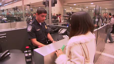 Passengers-Coming-Into-An-International-Airport-Terminal-Pass-Through-Us-Customs-And-Are-Photographed-And-Fingerprinted-3
