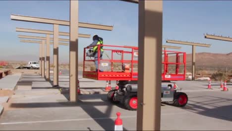Construction-Workers-Build-A-New-Solar-Parking-Structure-In-The-Desert