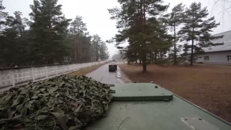 The-Latvian-Army-Moves-Across-A-Simulated-Battlefield-In-Tracked-Tanks-And-Vehicles