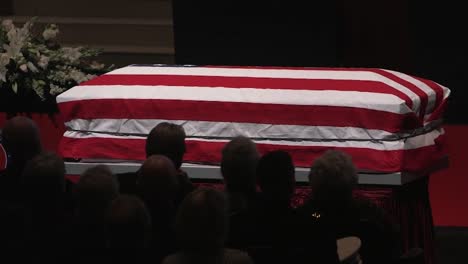 A-Patriotic-Flag-Draped-Coffin-Sits-At-An-Official-State-Military-Funeral