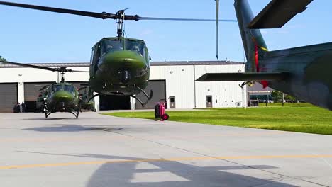 A-Squadron-Of-Huey-Helicopters-Rise-From-An-Airbase-In-Slow-Motion
