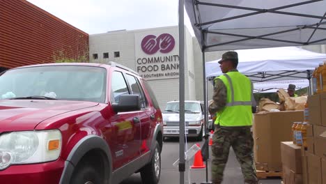 During-The-Covid19-Coronavirus-Epidemic-Outbreak-Members-Of-The-Armed-Forces-Hand-Out-Groceries-At-A-Food-Bank-In-Arizona