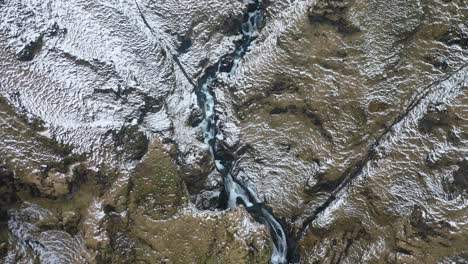 An-vista-aérea-view-shows-the-watery-route-that-leads-to-a-waterfall-during-winter-in-Iceland