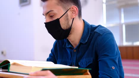 Young-Muslim-Wears-A-Mask-And-Reads-The-Quran-In-Mosque