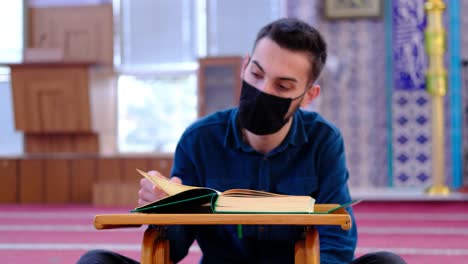 Young-Muslim-Weaing-A-Mask-Reads-The-Quran-In-Mosque
