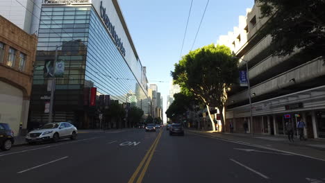 San-Francisco-California-passing-glass-building-and-cars