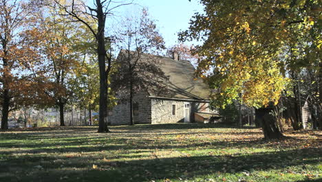 Trees-surround-an-old-stone-house-in-New-Paltz.