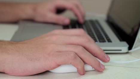 Man'S-Hands-Working-A-Laptop-Keyboard-And-Mouse-Looking