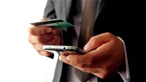 Businessman-Making-Online-Payment-With-Credit-Card-And-Smartphone-2