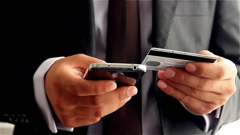 Businessman-Making-Online-Payment-With-Credit-Card-And-Smartphone