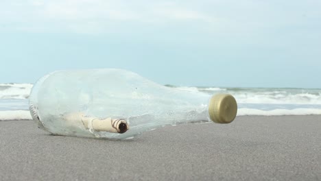 Message-In-A-Bottle-On-Sand-Beach