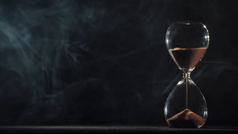 Hourglass-on-a-black-background-with-mist-swirling