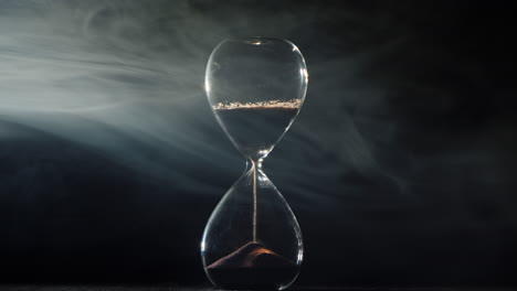 Hourglass-on-a-black-background-with-mist-swirling-1