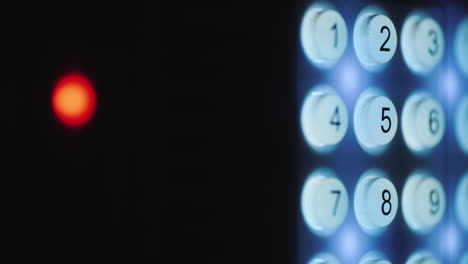 A-person-enters-a-pin-code-on-a-backlit-keyboard-1