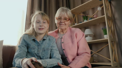 Grandmother-And-Granddaughter-Speak-To-Camera-During-Video-Call