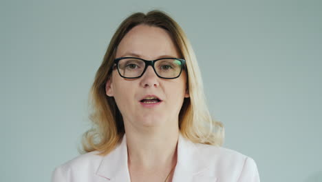 Woman-In-Glasses-Tells-A-Lesson-On-A-White-Background