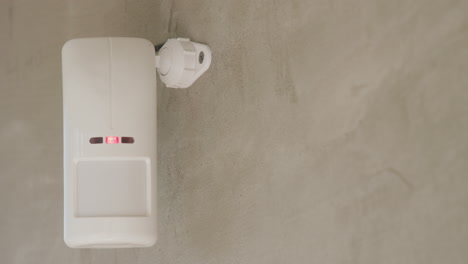 Security-alarm-sensor-on-the-wall-of-a-house