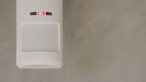 Security-alarm-sensor-on-the-wall-of-a-house-1