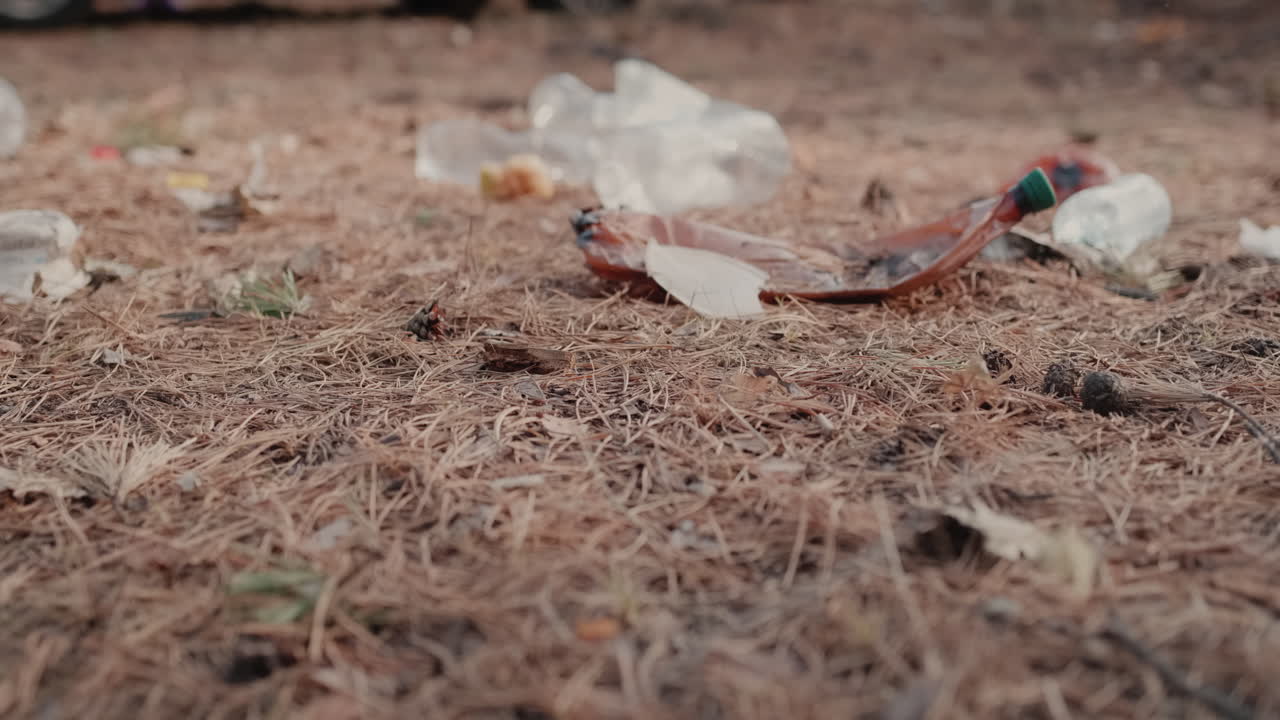 Premium stock video Medical masks and plastic lies on the ground in